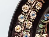 a black plate with a floral design on it