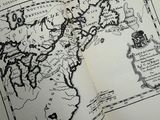 an open book with a map of the world on it