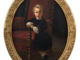 portrait of a young boy in a black dress sitting on a red chair