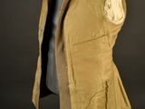 an image of a jacket on a mannequin stand with a black background