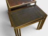 pair of brass nesting tables with glass tops