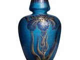 a blue vase with a gold design on it