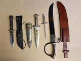 several different types of knives are lined up on a table
