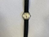 an image of a watch on a white surface with a black strap