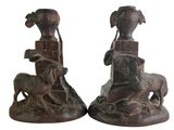 two statues of a man and a woman with animals on them