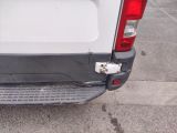a white van parked in a parking lot with its door open