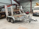 a truck with a trailer attached to it in a garage