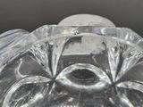 a glass figurine of a face on a black background
