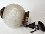 a white ball with a chain around it on a white surface