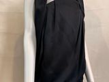 the mannequin is wearing a black top and white leggings