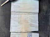 a car key and a receipt sitting on the seat of a car