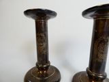 two vases that are sitting on a table