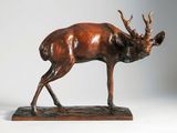 bronze sculpture of a stag standing on a wooden base