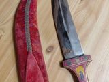 two knives that are on a wooden table