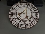 a clock that is sitting on a table in front of a keyboard