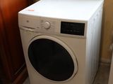 a white washer and dryer in a small room