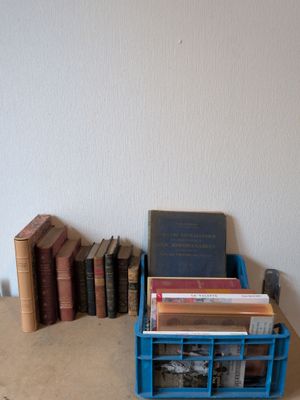 une pile de livres posée sur une table, à côté d'une autre pile de livres