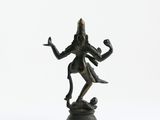 an image of a bronze statue of a person on a rock