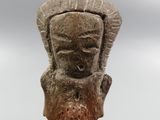 an image of a stone head on a stand against a cloudy sky
