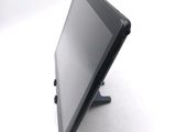 a tablet computer sitting on a stand on a white surface