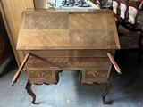 a wooden desk with two drawers in a room