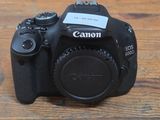 a canon camera sitting on a wooden table