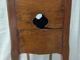 a wooden chair with a hole in the back of it