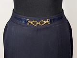 a close up of a black dress with a gold buckle on it