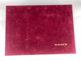 a close up of a red folder with a gold logo on it