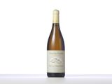 a bottle of white wine sitting on top of a table