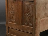 a small wooden chest on a dolly on a wooden floor