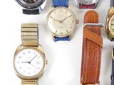 a lot of watches that are sitting together on the table