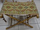 a small stool with a woven seat on top of it