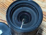 a black camera lens sitting on a wooden table