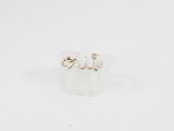 gros plan d'une paire de boucles d'oreilles sur une surface blanche