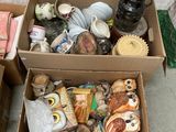 two boxes of assorted items sitting on the ground