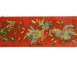a picture of a red tile with birds on it
