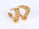 pair of gold tone cuff earrings with a chain design
