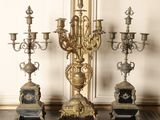 three ornate candelabs sitting on a table in a room