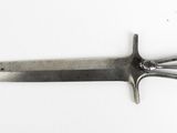 an image of a knife that is laying on a white surface