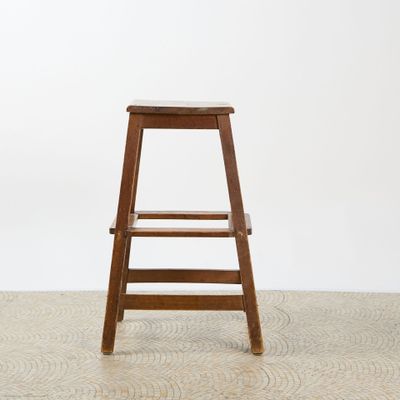 an image of a wooden stool sitting on top of a white floor