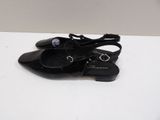 the black shoes are sitting on the table on the white surface