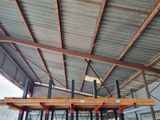 a picture of a large warehouse with a metal roof