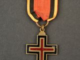 a close up of a medal with a cross on it