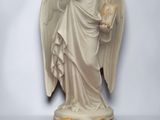 an image of a statue of an angel holding a book