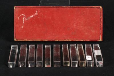 six cassettes are lined up in a red case on a black surface