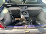 the back of a car with a bunch of items in the trunk