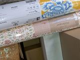 several rolls of wrapping are stacked on top of each other in a store