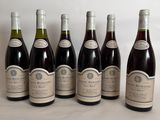 six bottles of wine lined up in a row on a table