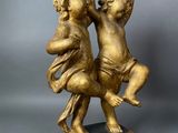 an antique bronze figurine of two cherenshes on a marble base
